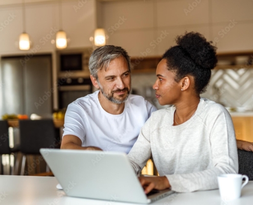 Couple using computer to plan for retirement