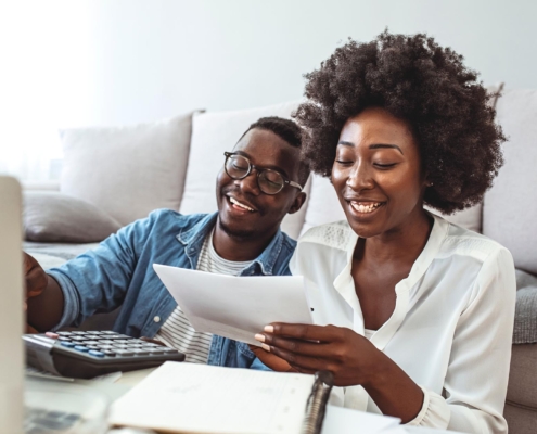 Young couple looking over financial plans at home