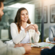 Front view of woman smiling while in meeting with investor