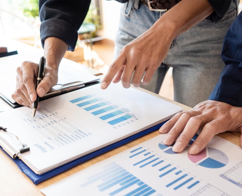 Two business people looking over charts of finances