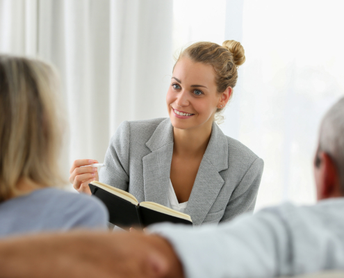 Front view, life insurance rep talking to older couple